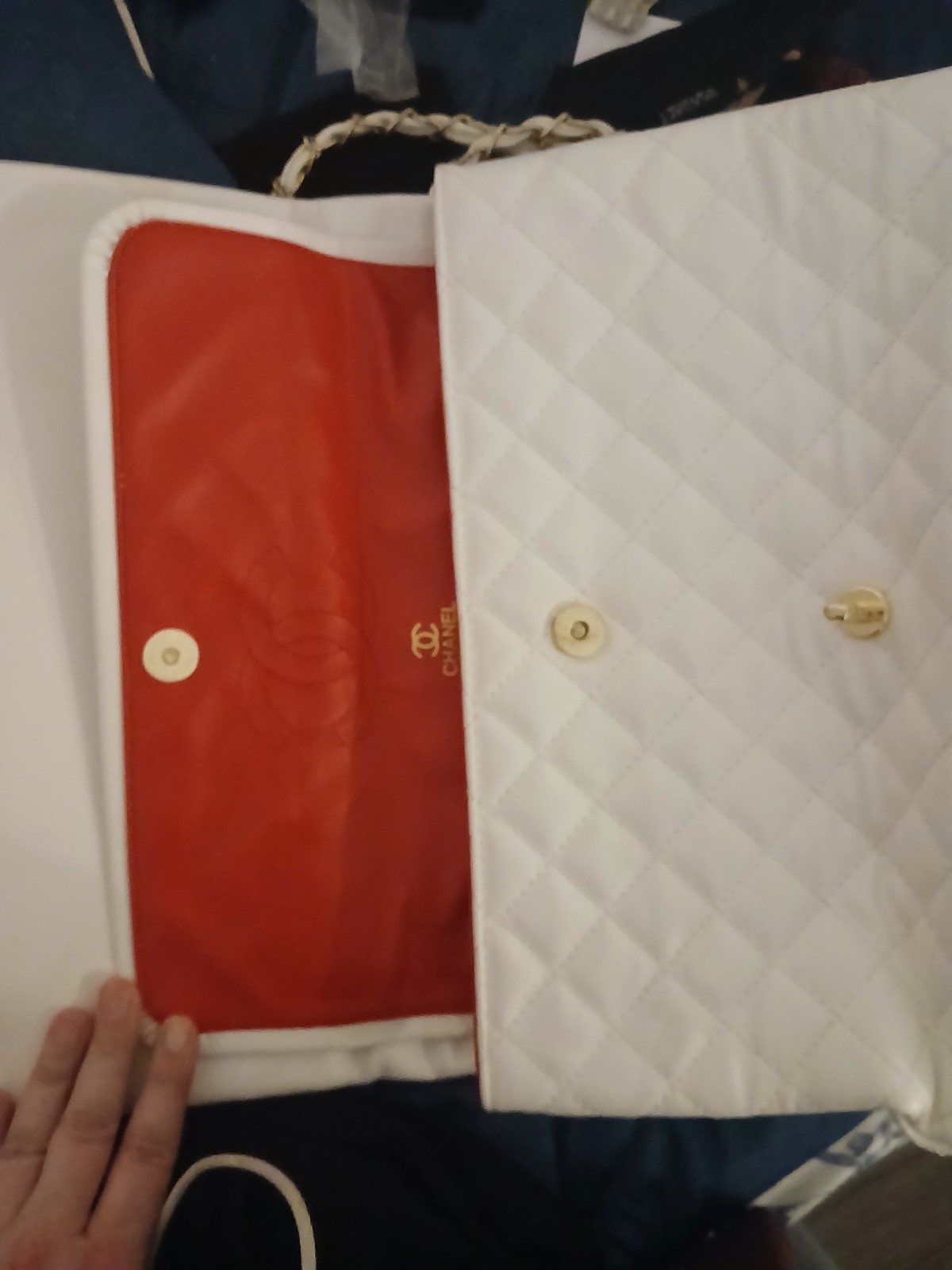 white chanel bag with red interior and a double clasp