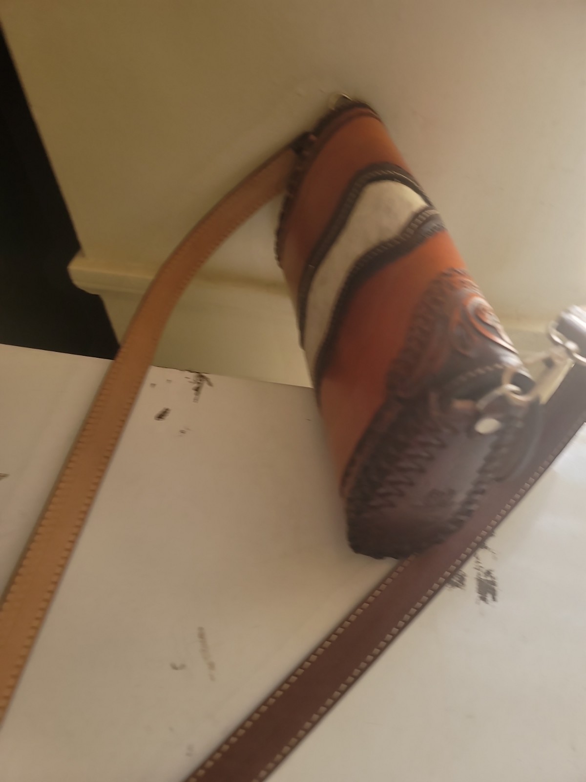 hand-tooled Western leather and hair-on-hide barrel bag