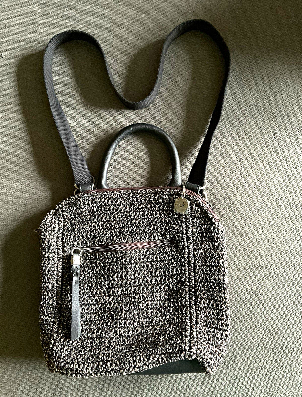 The Sak Gray Small Crossbody Bag Zip Closure Lined Pockets Charm Black Strap
