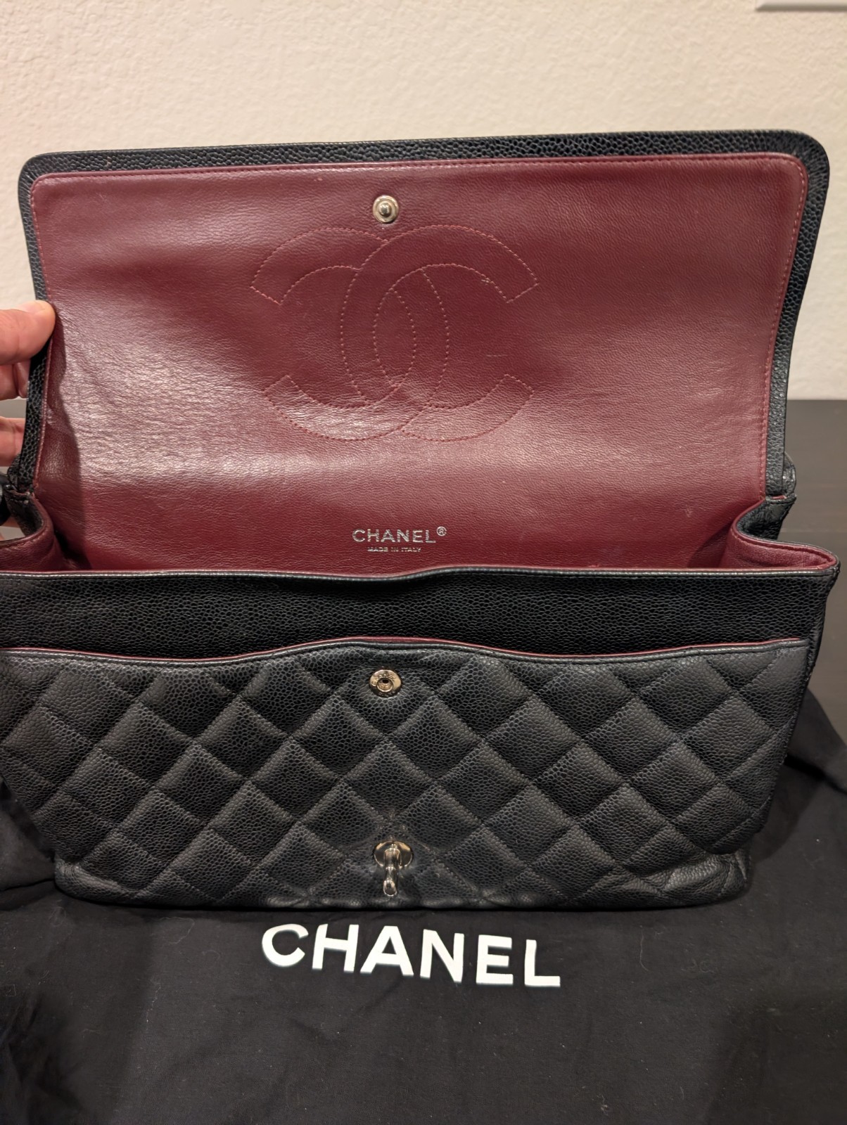 CHANEL Maxi Classic Double Flap Caviar Black Leather Bag. Circa 2011 Storyline