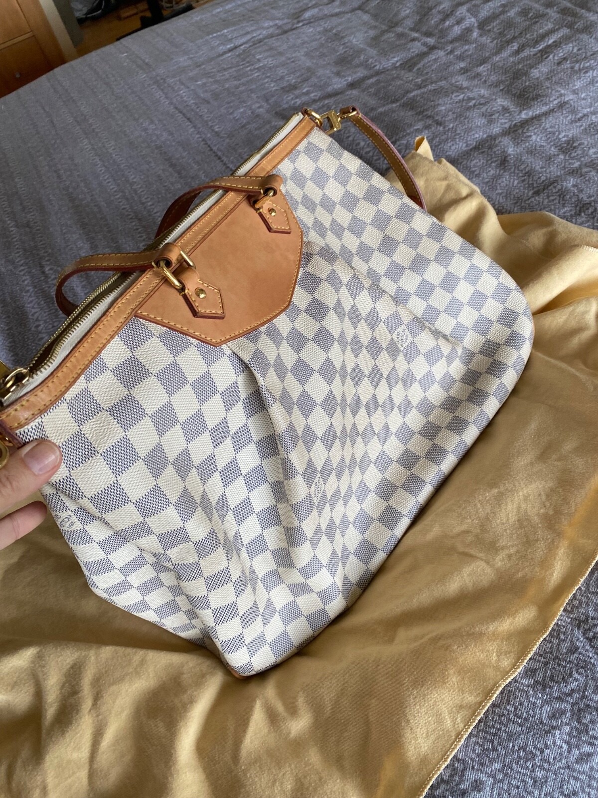 Louis Vuitton Siracusa GM in the classic Damier Azur .