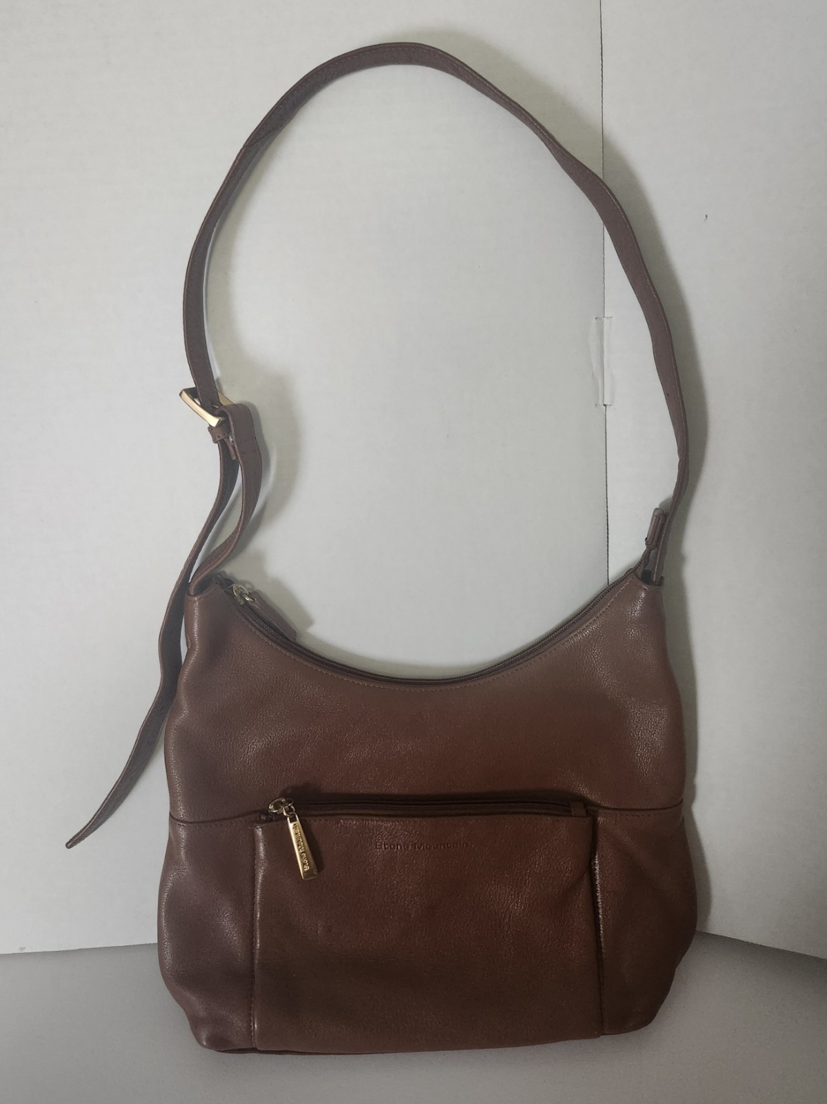 Stone Mountain Brown Leather features a brass-toned zipper pull.(8061)