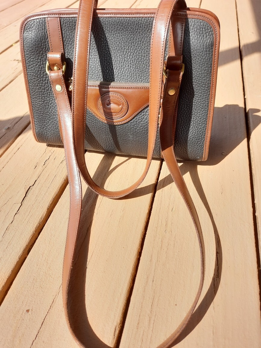 Dooney and Bourke Black With Brown Trim Leather Handbag