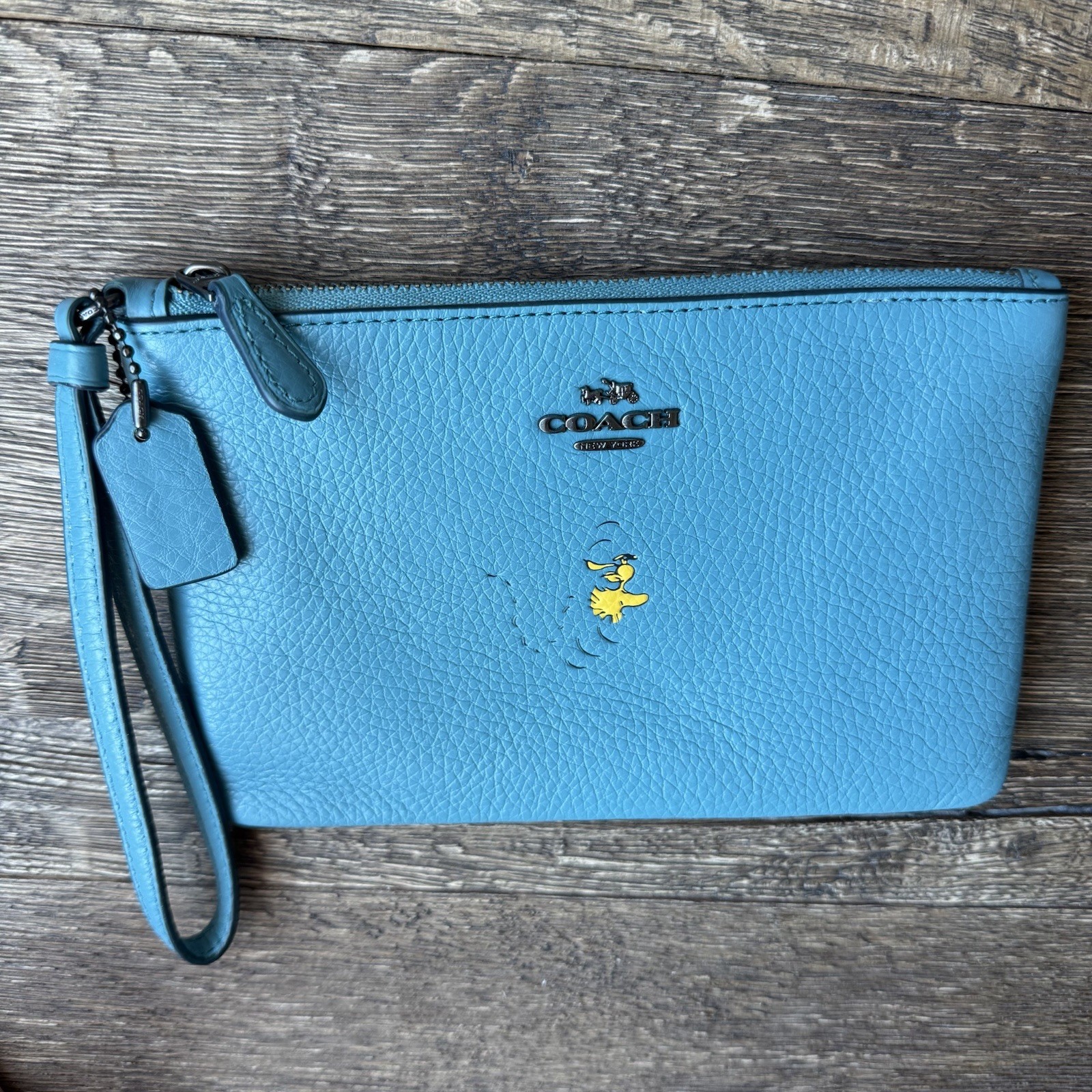 Coach x Peanuts Corner Zip Wristlet with Snoopy motif