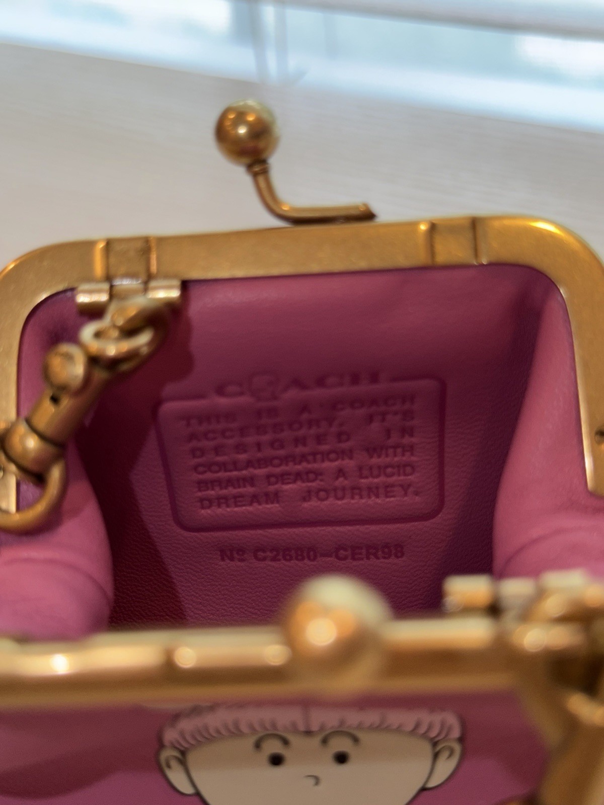 COACH Brain Dead Kisslock Neck Pouch With Xerx Alien Leather/Brass/Pink CER98