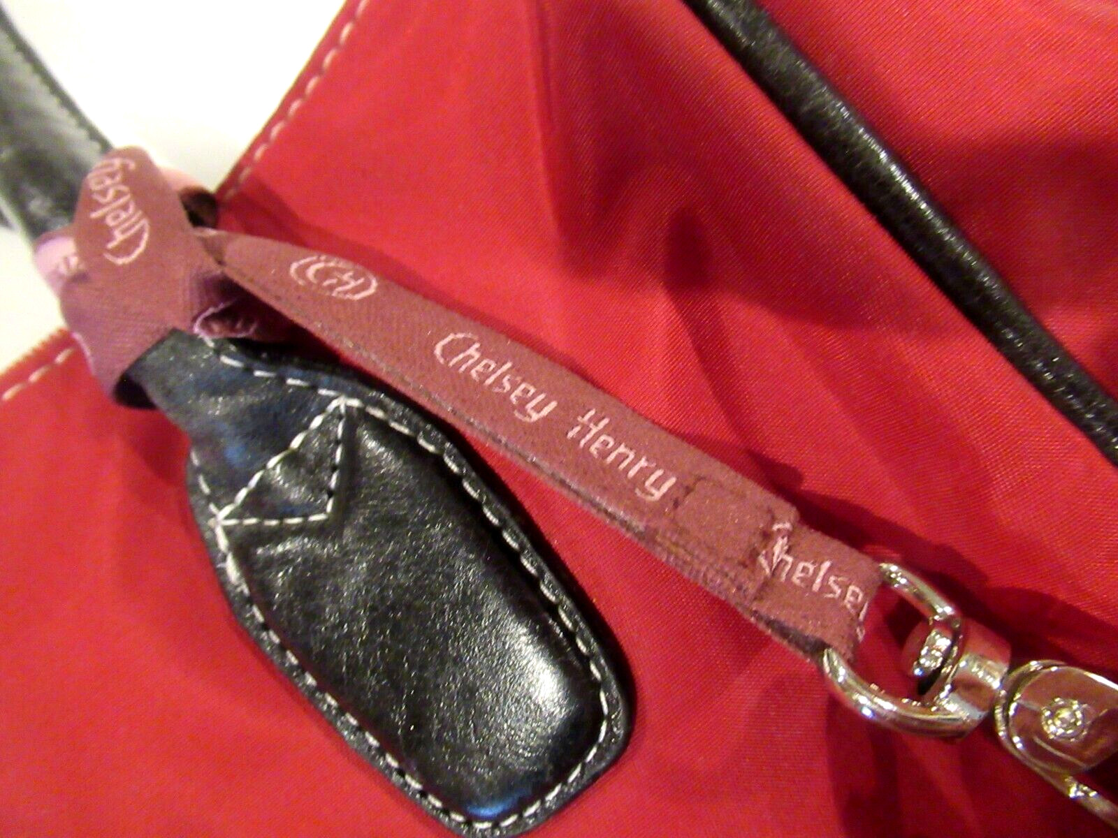 Chelsey Henry red purse with black trim, lots of pockets