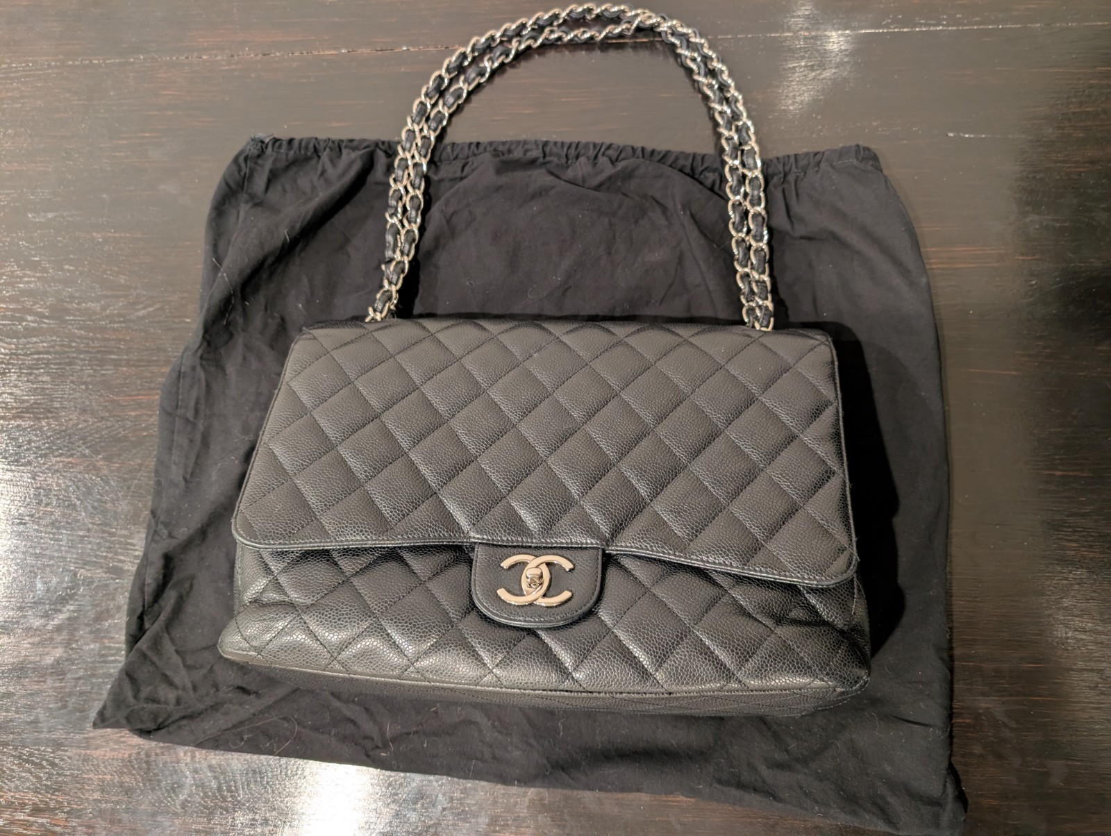 CHANEL Maxi Classic Double Flap Caviar Black Leather Bag. Circa 2011 Storyline