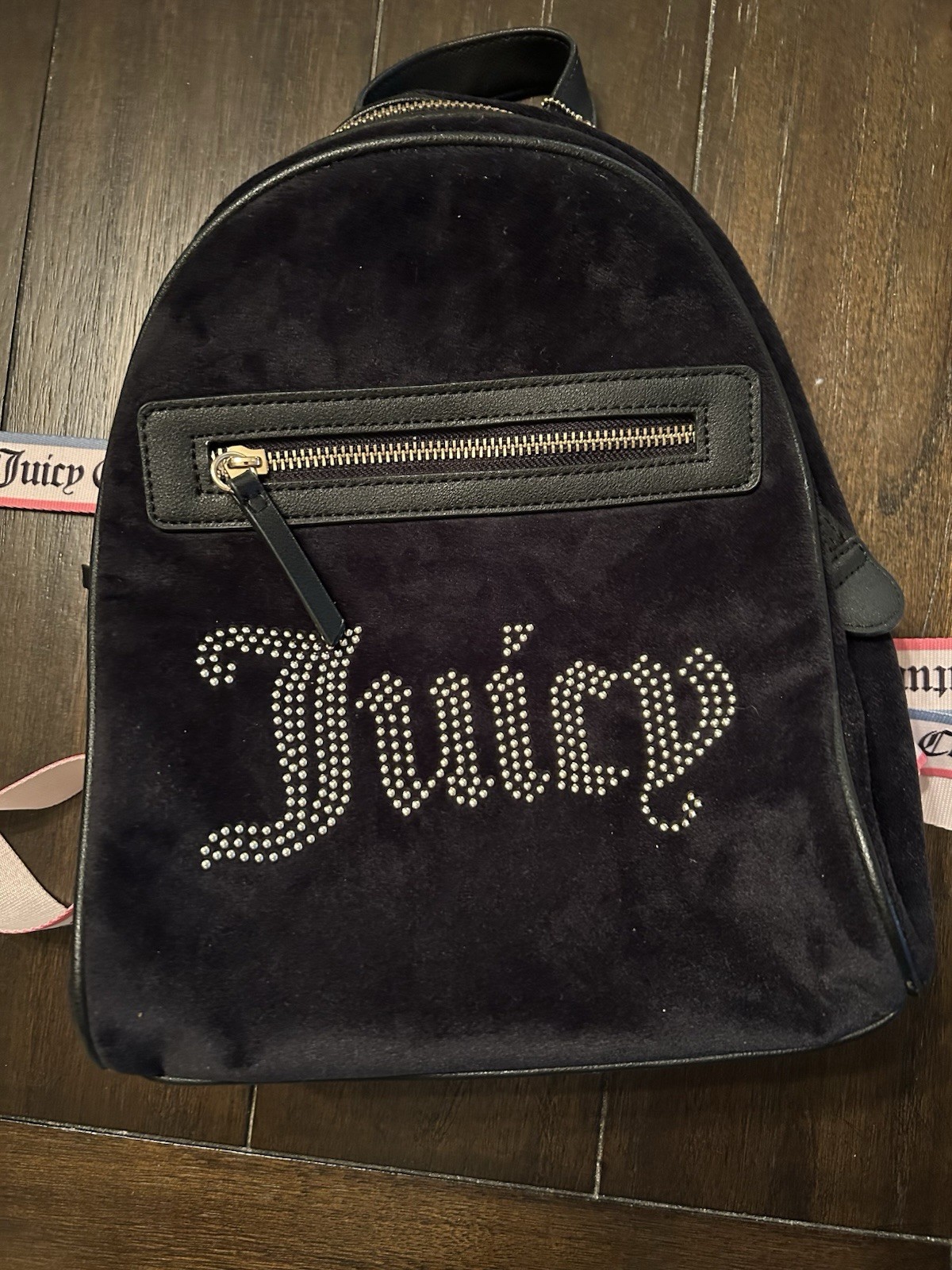 Juicy Couture mini backpack features a sparkling rhinestone “Juicy” logo