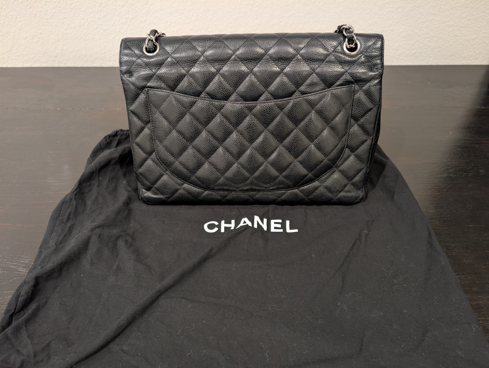 CHANEL Maxi Classic Double Flap Caviar Black Leather Bag. Circa 2011 Storyline
