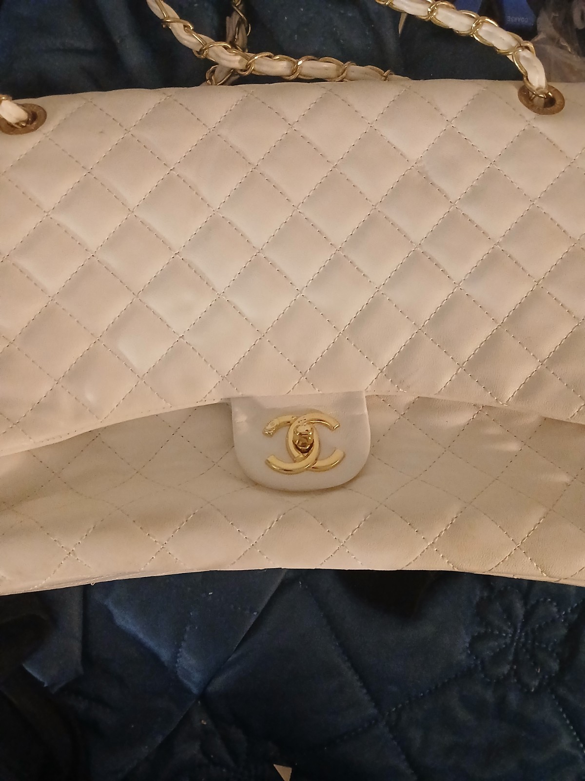 white chanel bag with red interior and a double clasp