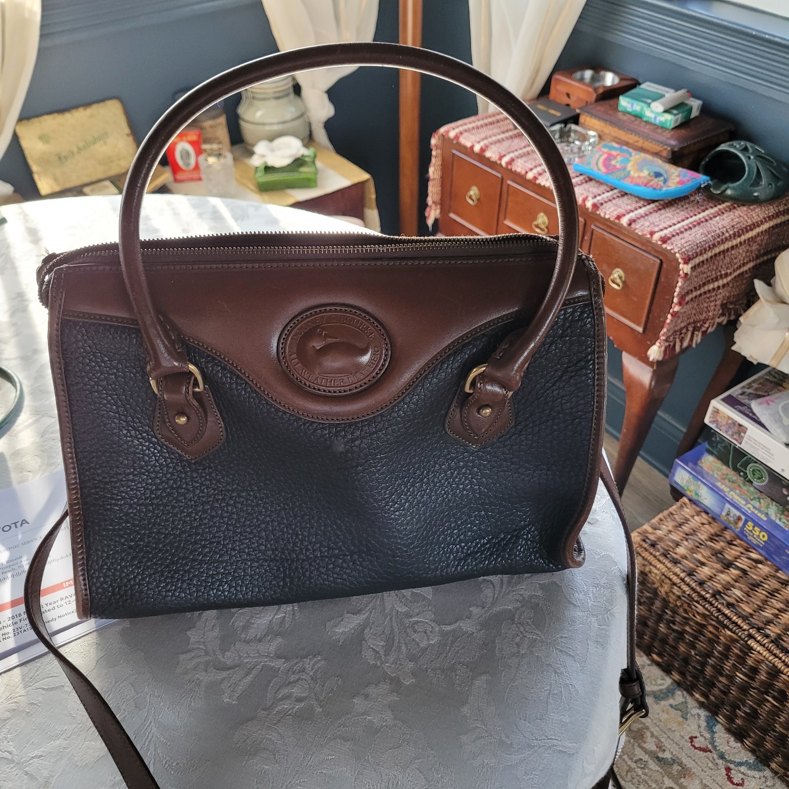 Dooney & Bourke USA Leather Black With Brown Trim, Pebble Finish.