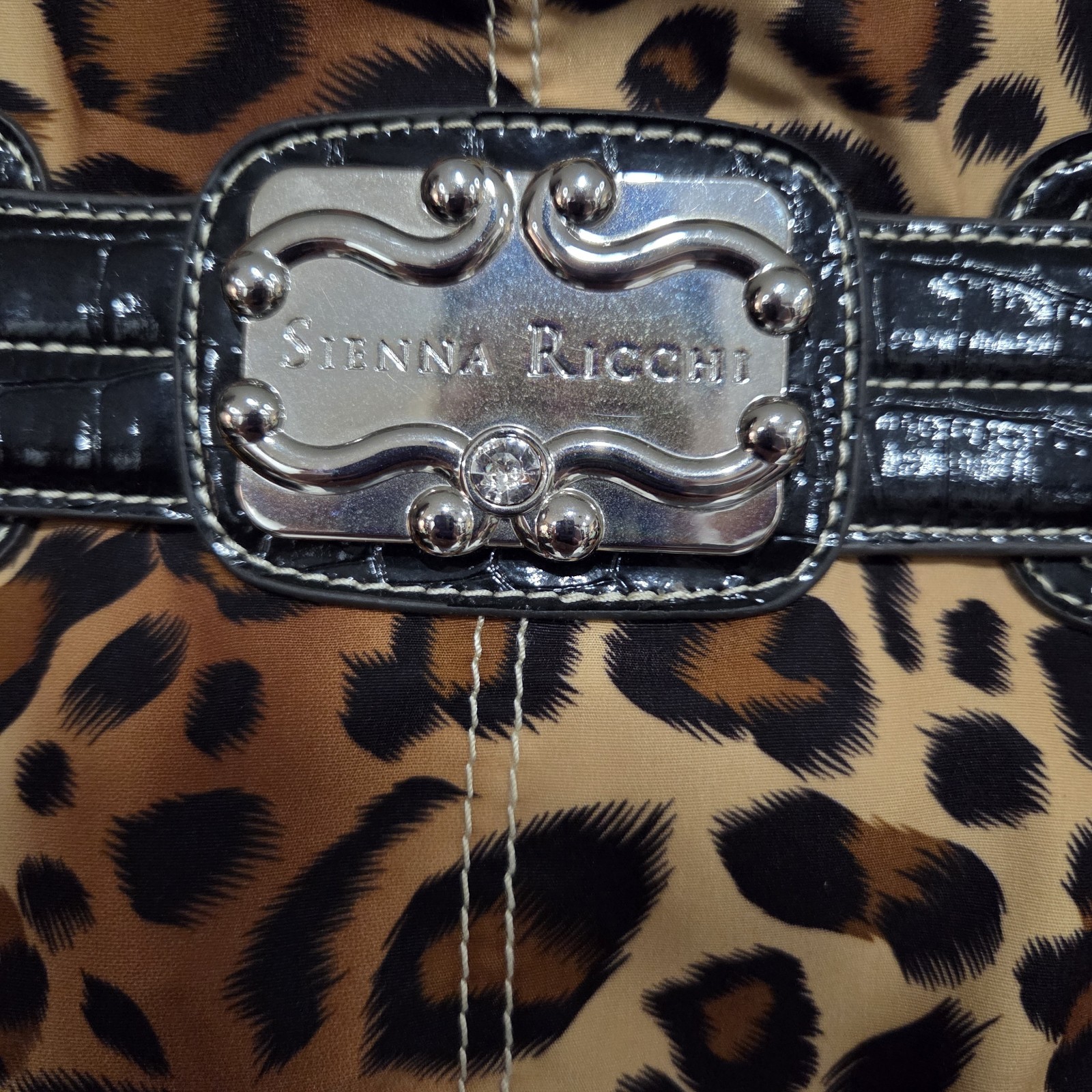 Sienna Ricchi Leopard Print handbag featuring black patent leather handles