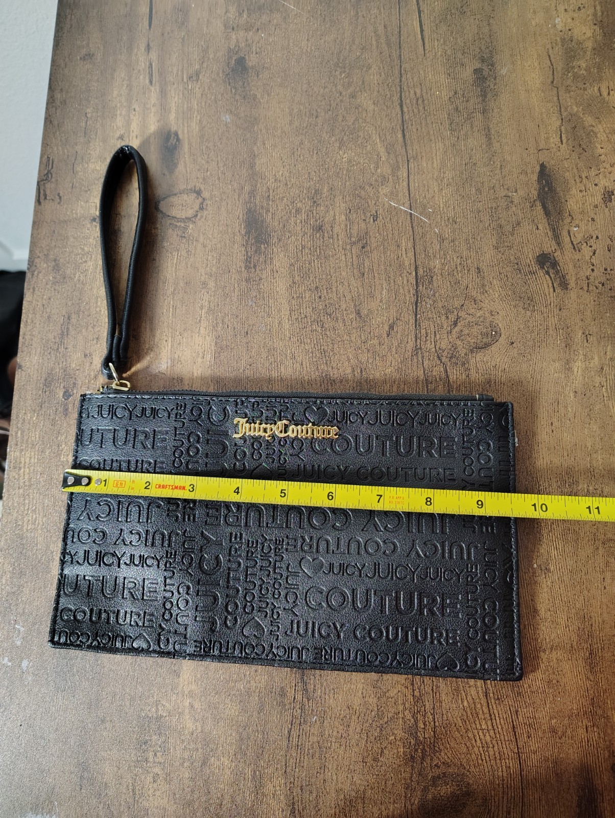 Juicy Couture Black Hand Zip wristlet embossed monogram pattern 5.5in x 9.5in