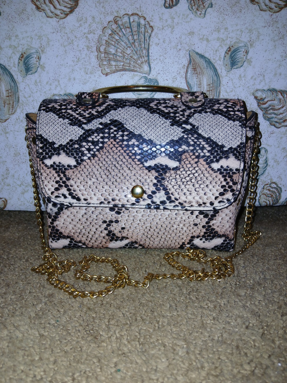 Small Bag That Can Be Hand Held And Has A Over The Shoulder Chain Strap