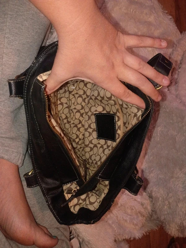 coach purse does have a small tear on the latch part of the handle