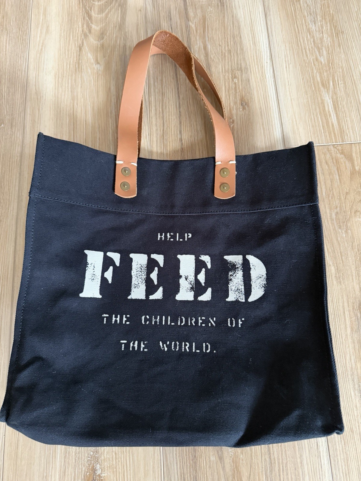 FEED Children Of The World Black Tote Bag Brown Leather Handles 13in HELP