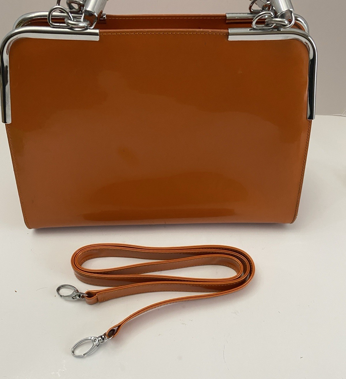 MC Collection handbag Glossy Orange with Braided silver handle and strep Pre own