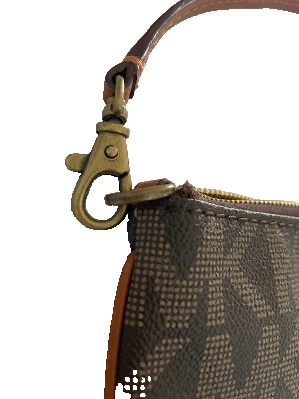 Michael Kors small underarm purse or carry on. You can carry your phone in it.