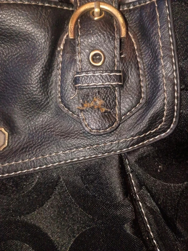 coach purse does have a small tear on the latch part of the handle