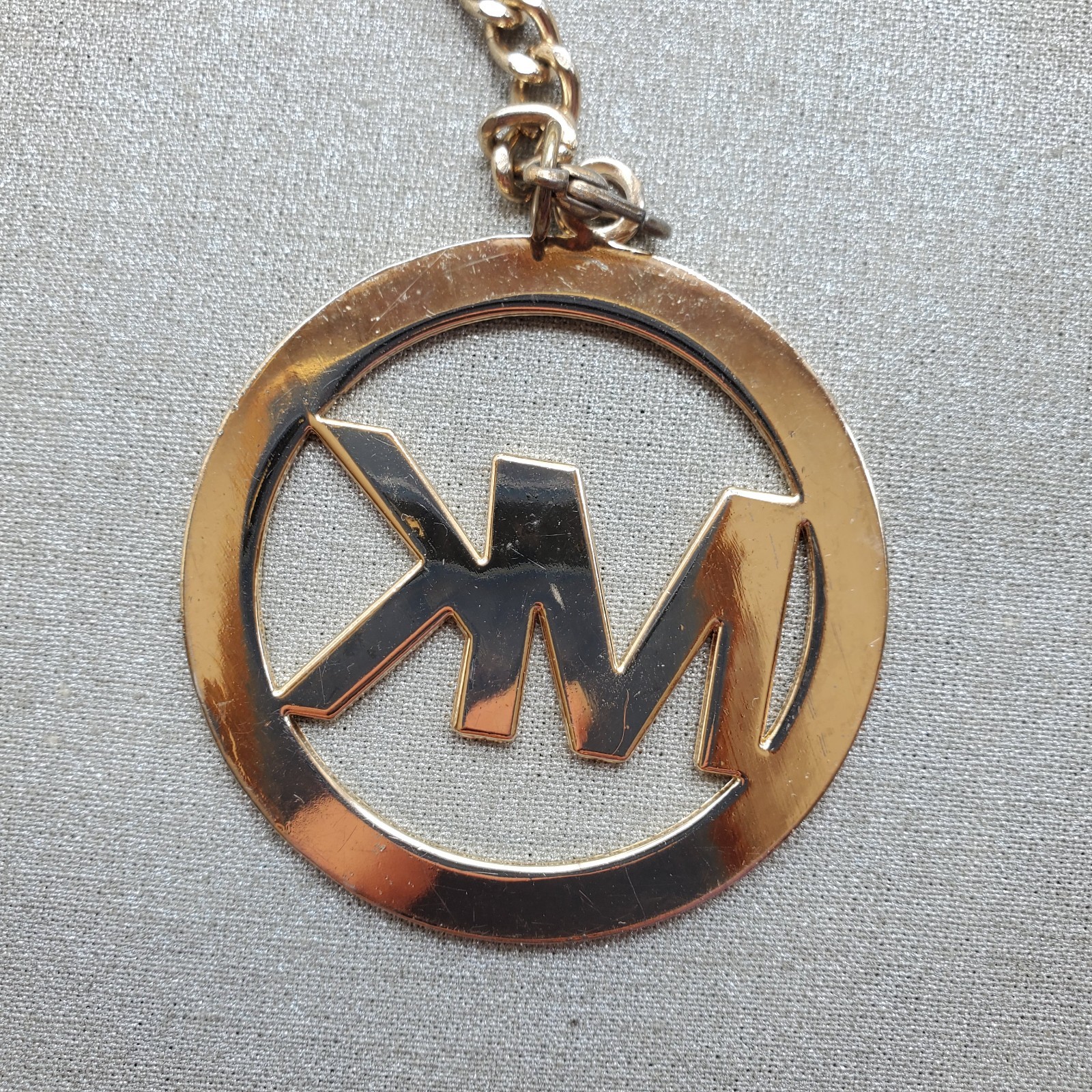 Michael Kors Round Gold Tone Clip On MK Purse Charm w Carabiner