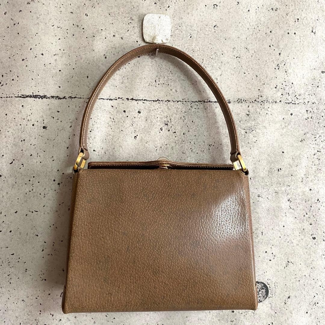 GUCCI Handbag Brown Leather Turn-lock Closure Size: WxH7 in. Strap: 18.9″
