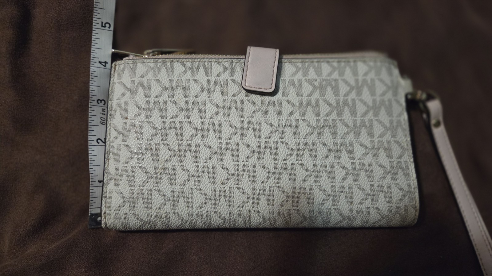 Michael Kors Jet Set Travel wristlet features the signature logo PVC monogram