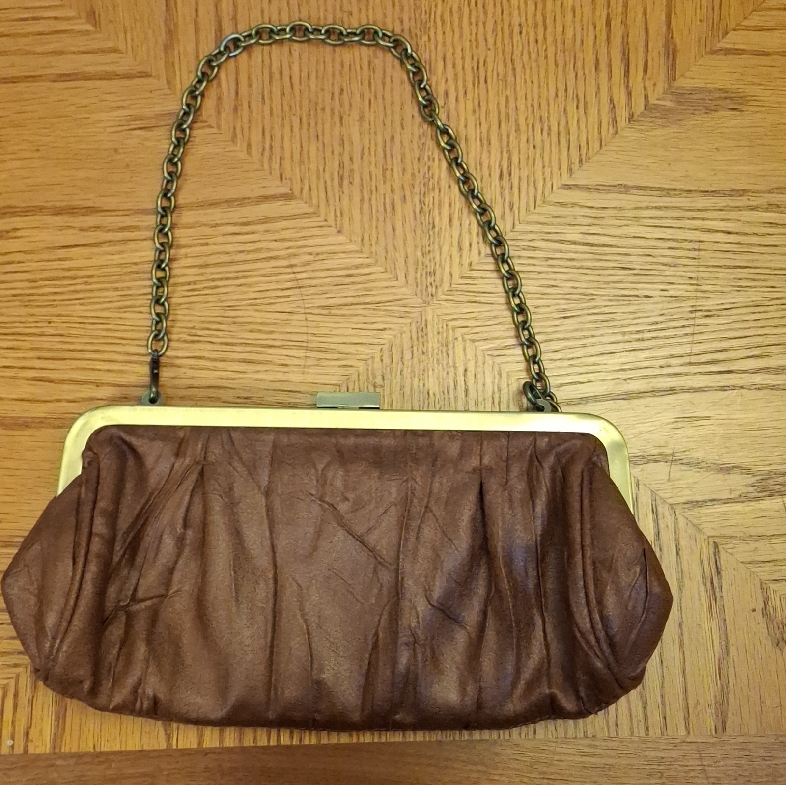 Brown Clutch Purse Metal Chain With Shoulder Strap, Clasp, And Zipper Pockets.