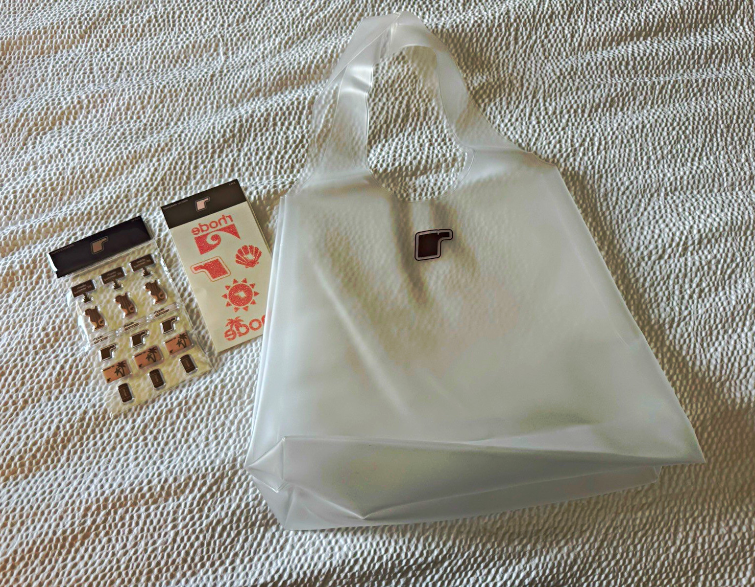 Rhode White Plastic Tote with stickers and temporary tattoos