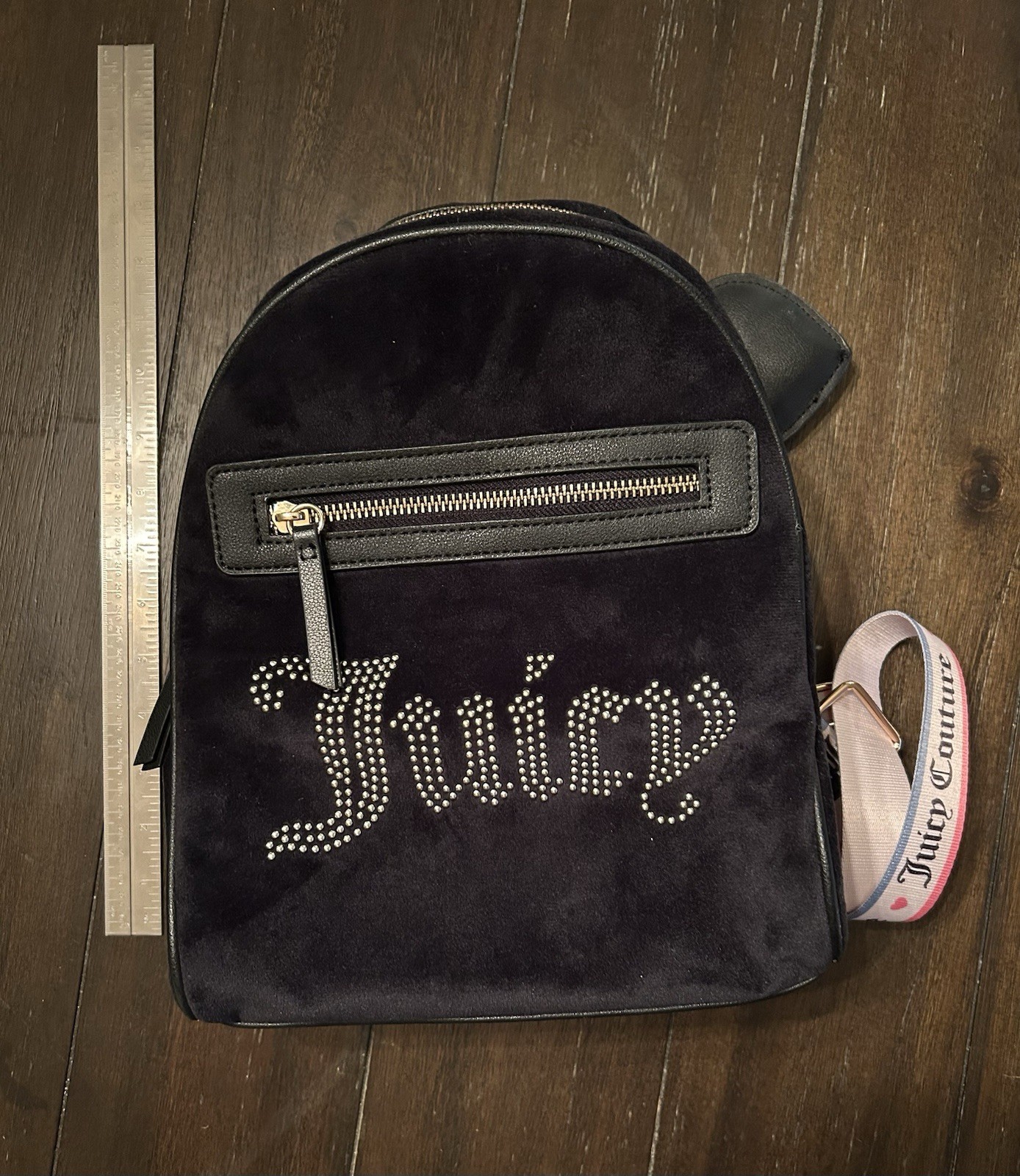 Juicy Couture mini backpack features a sparkling rhinestone “Juicy” logo