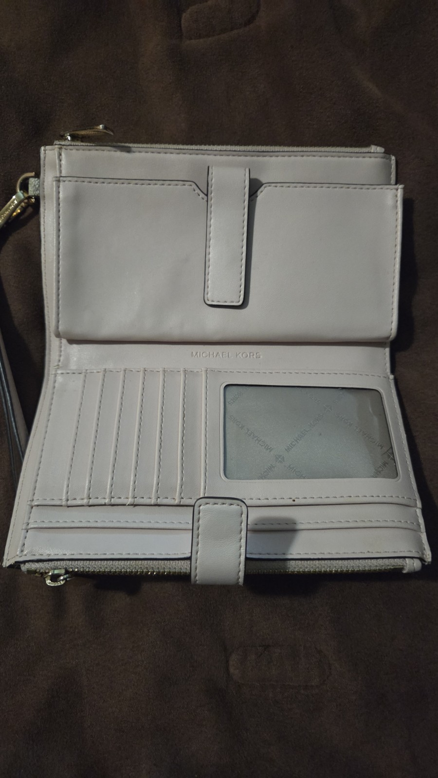 Michael Kors Jet Set Travel wristlet features the signature logo PVC monogram