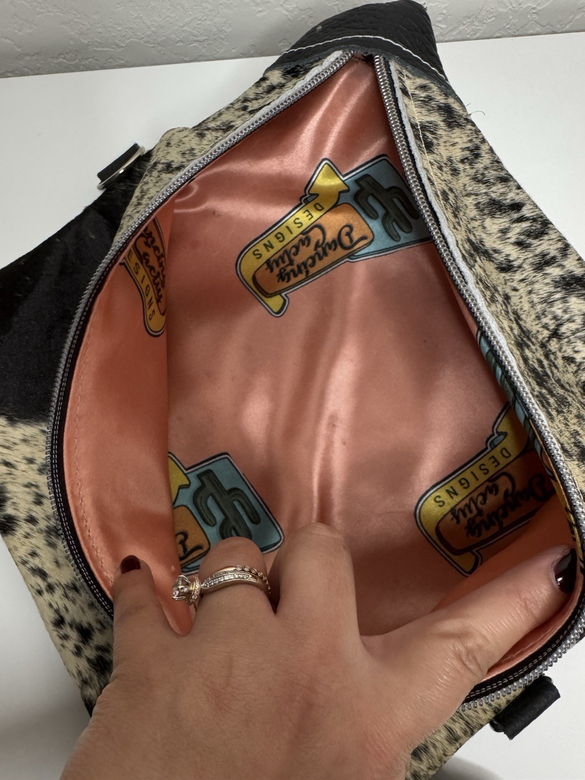 Dancing Cactus Designs Cowhide Print Leather Cosmetic Bag Tassel & Zip Closure