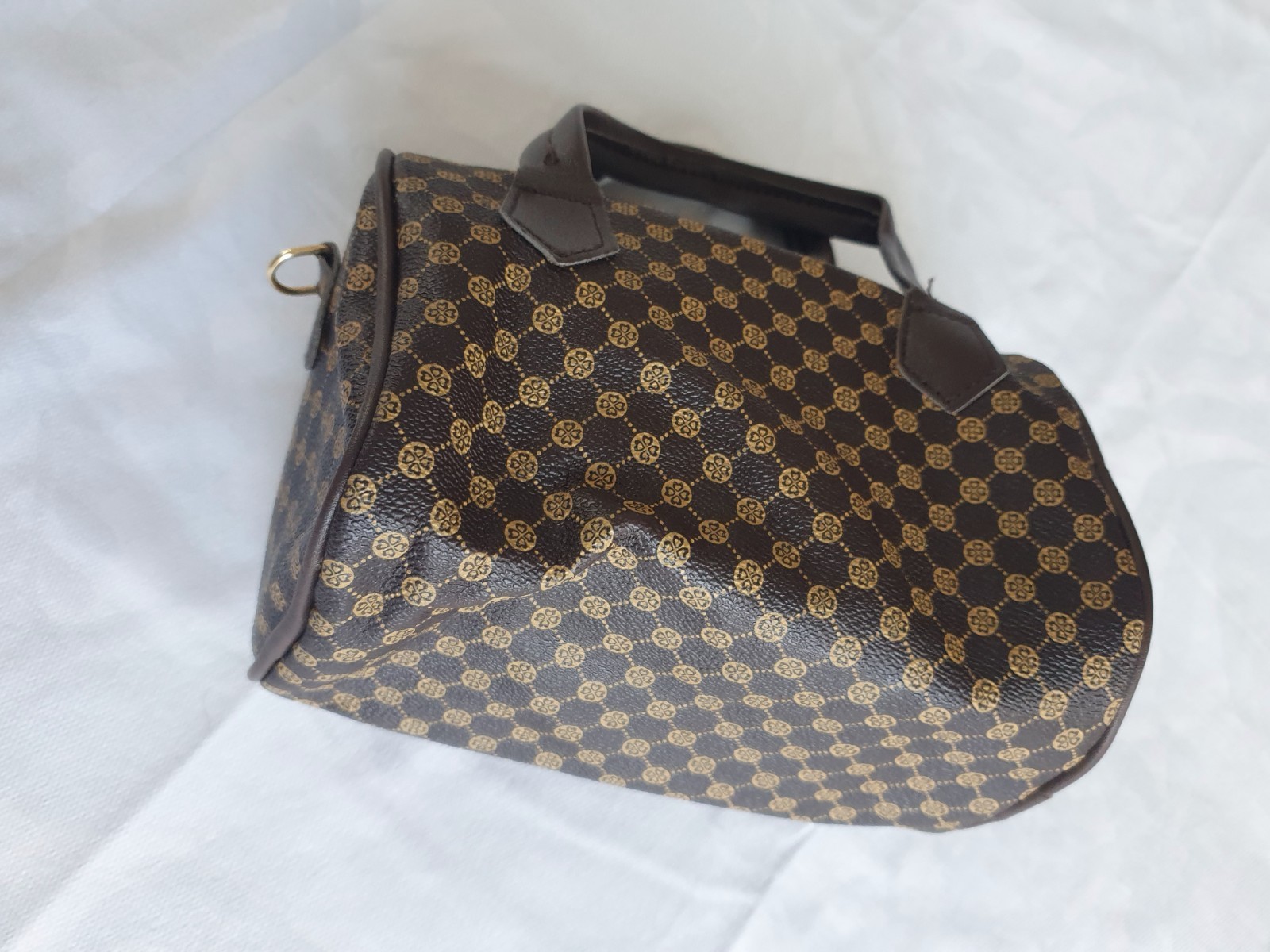 Brown handbag with a handle and elegant geometric pattern for women