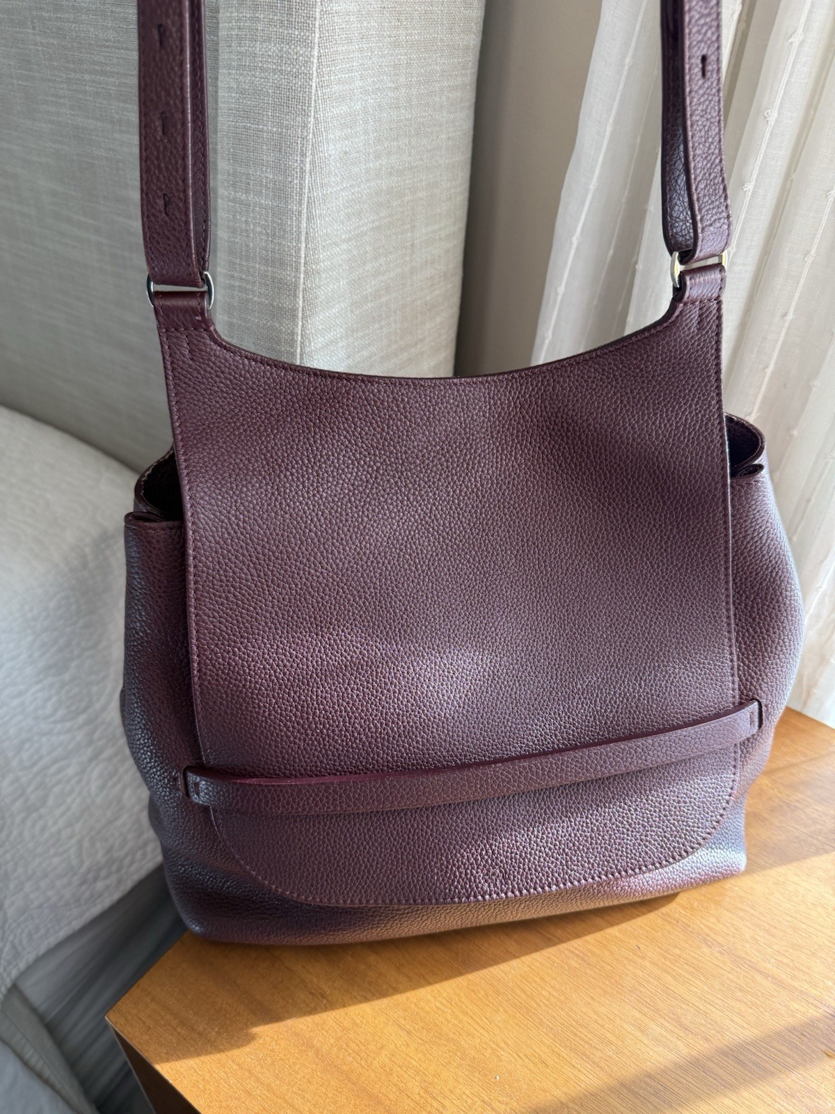 THE ROW Sideby crossbody in pebbled calfskin, burgundy. Made in Italy.