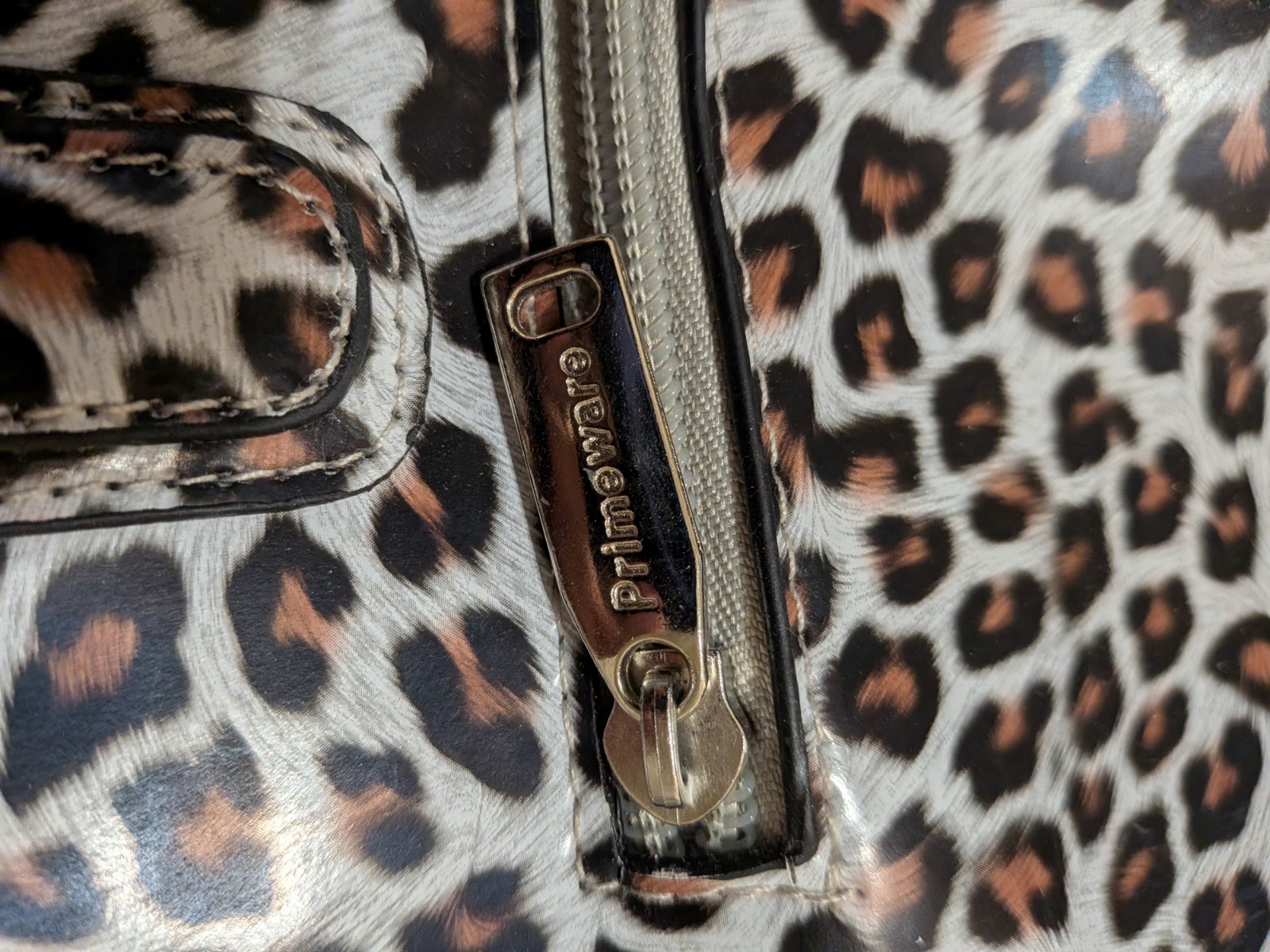 Primeware insulated drink purse features a fashionable white cheetah print