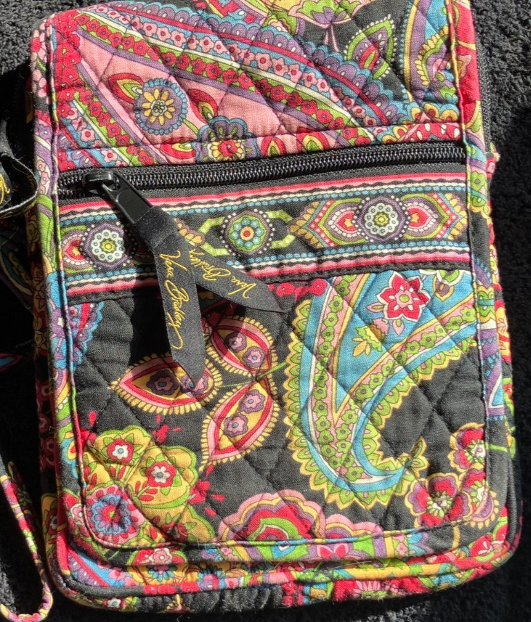 Vera Bradley small bag. Dramatic red on black, front flap, I.D, clear pocket