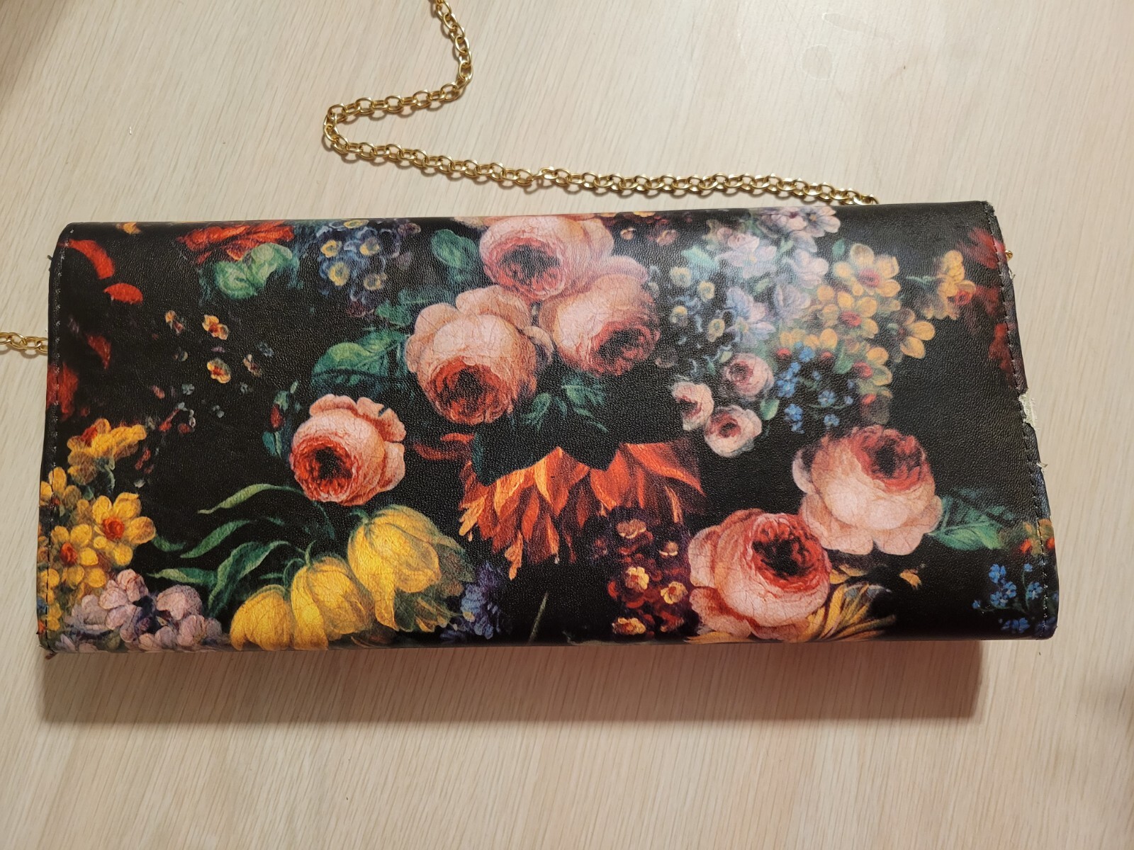 Large! About 15″ long. Very pretty vintage floral clutch on a removable chain.