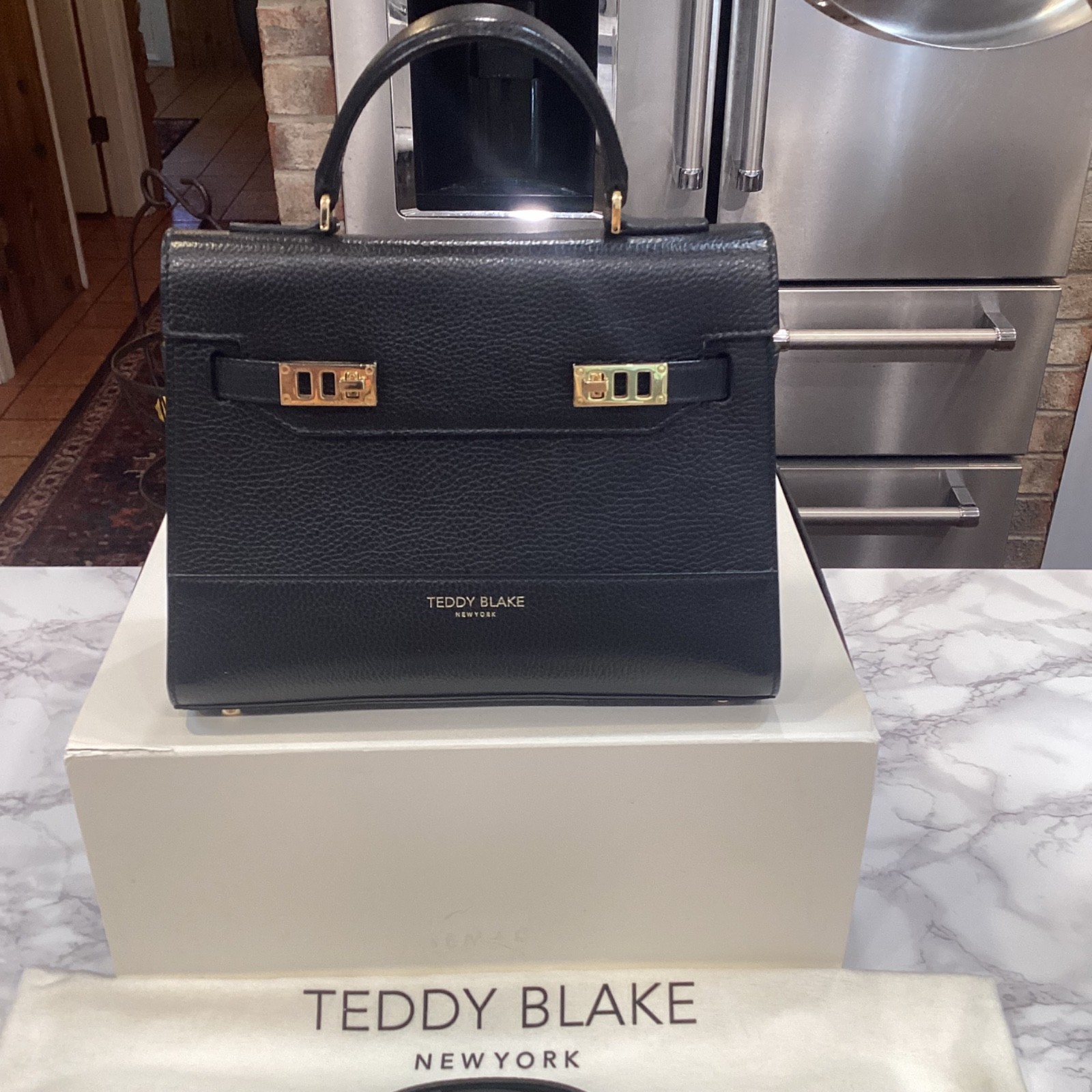 Preowned excellent Teddy Blake: Kim Stampato 11″ – Black With Gold Hardware