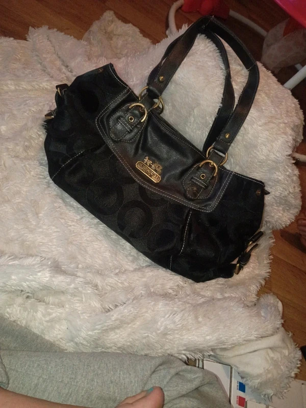coach purse does have a small tear on the latch part of the handle