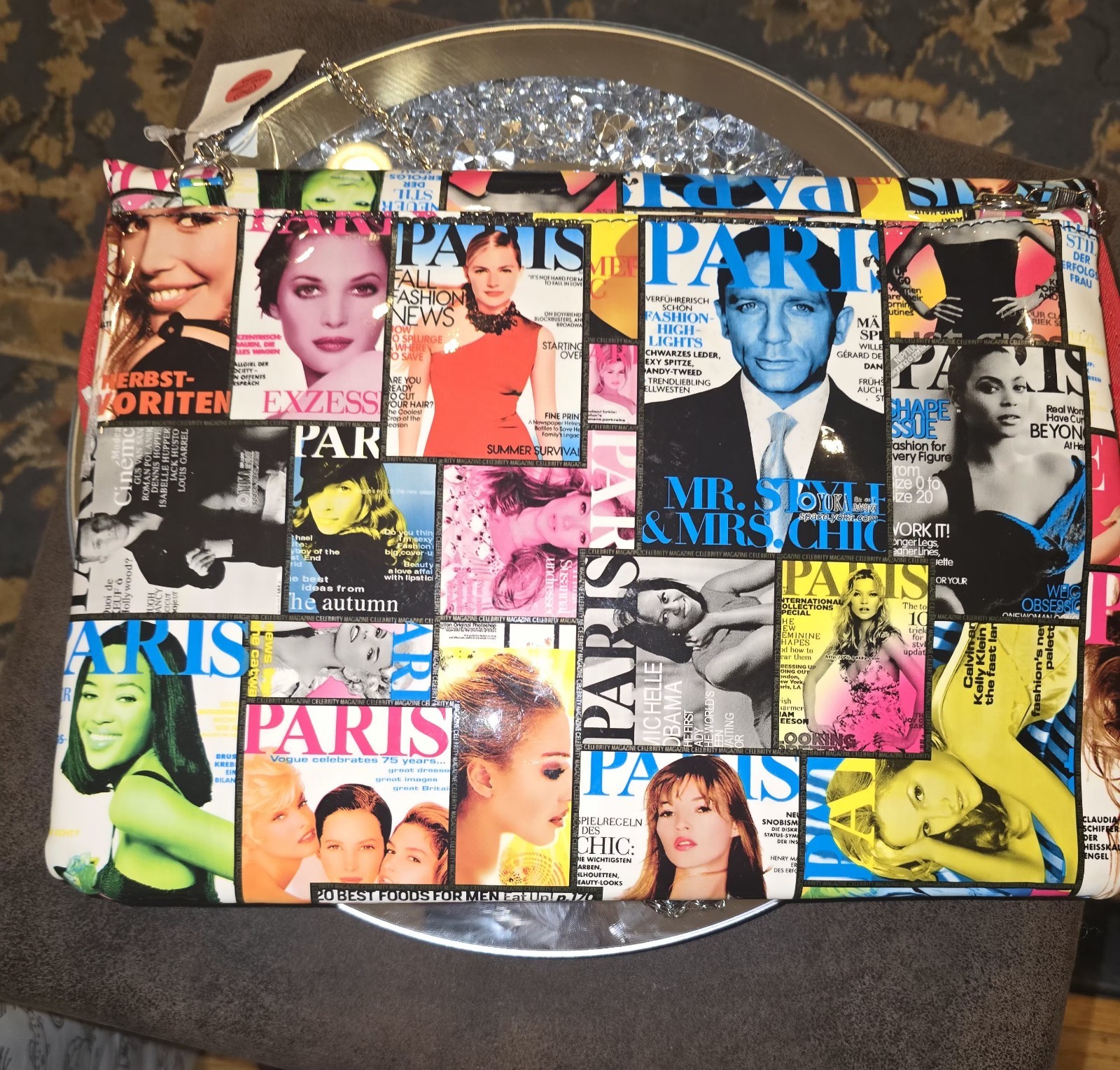Vintage envelope handbag comes with a chain strap with iconic magazine cover art