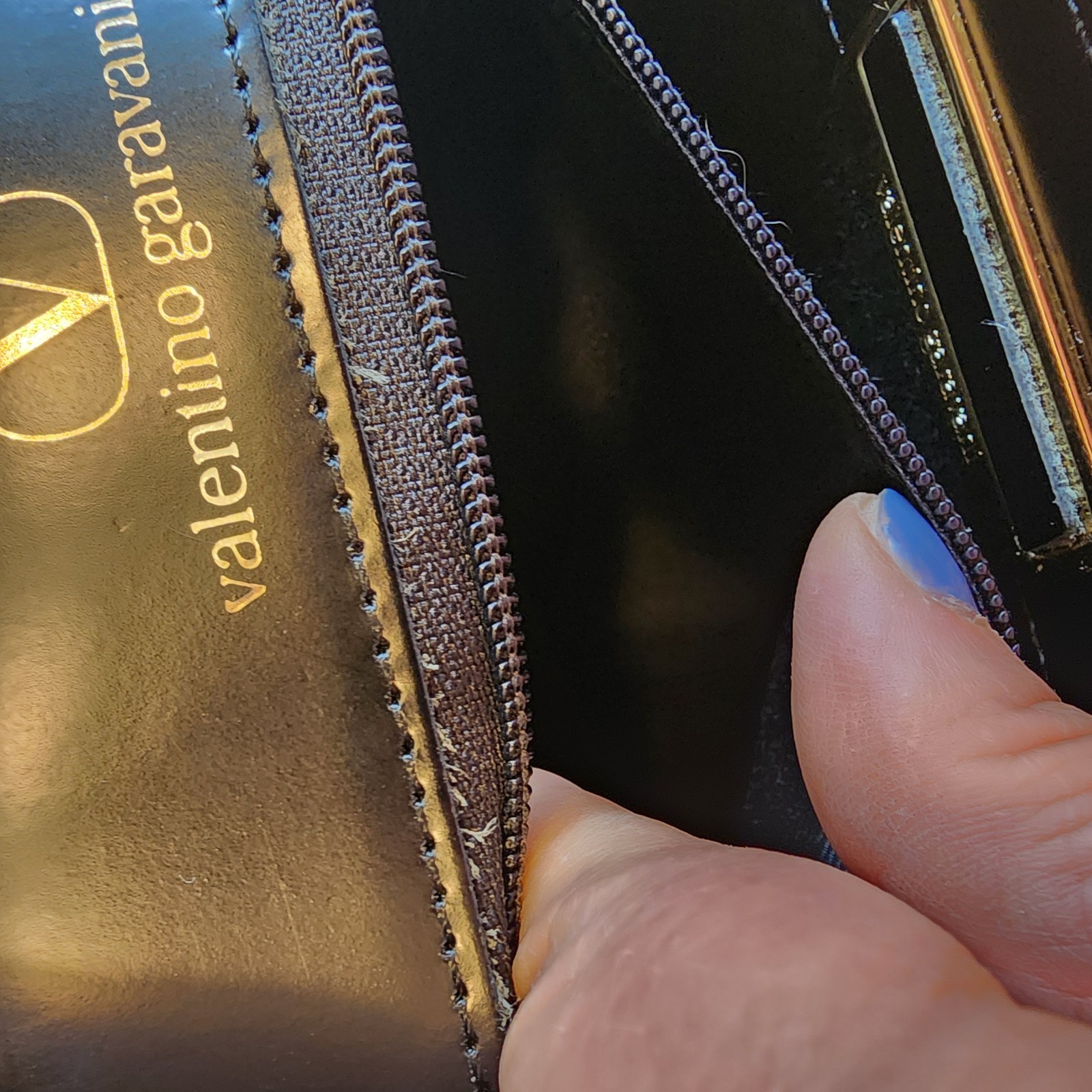 Valentino Garavani Vain clutch bag in black shiny calfskin leather