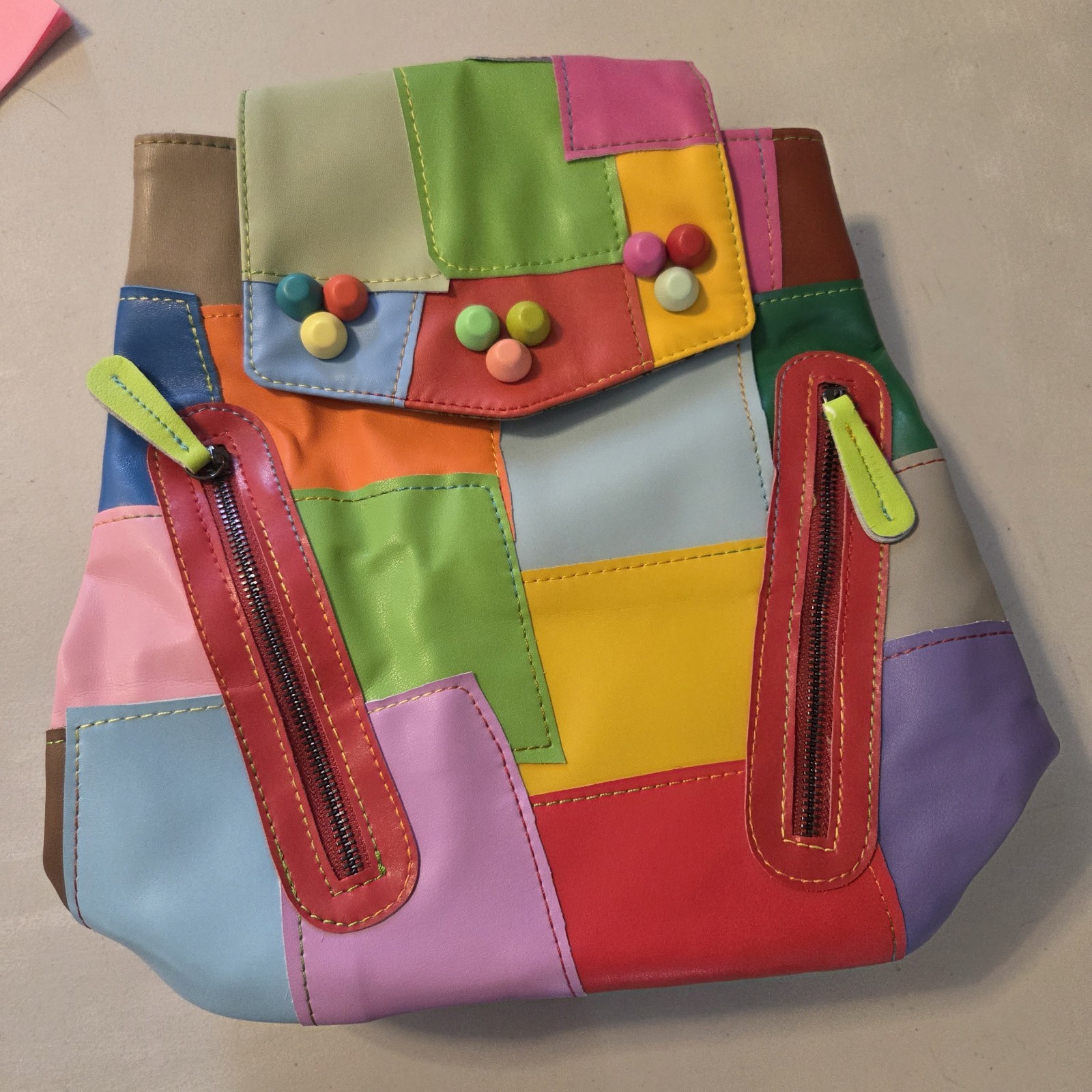 Eysee Fashion Backpack With vibrant leather blocks and unique buttons accents