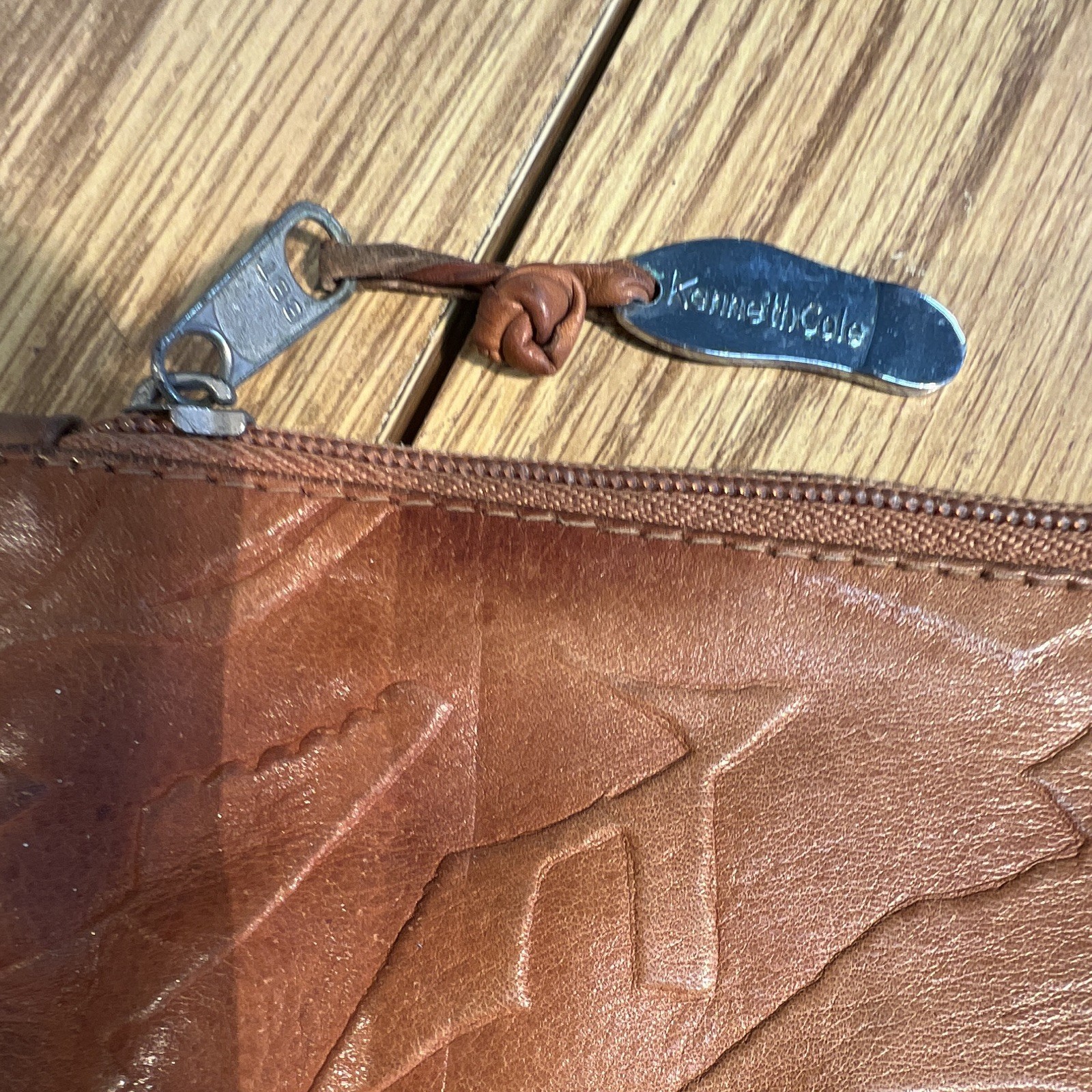 Kenneth Cole New York Brown Embossed Shoe Pattern Zip Clutch Wrist Strap