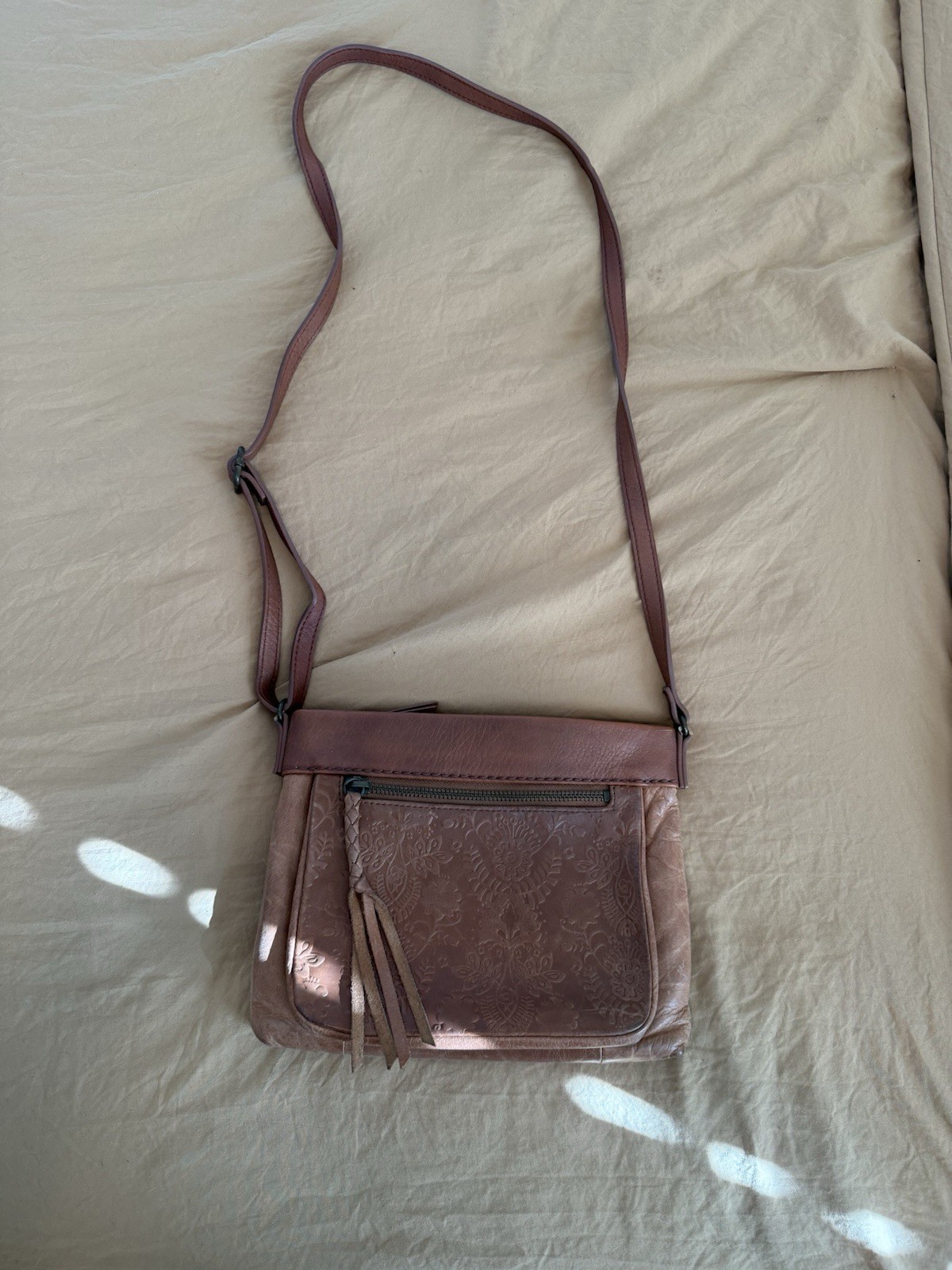 The Sak Brown Floral Crossbody Bag. This purse has been well loved.