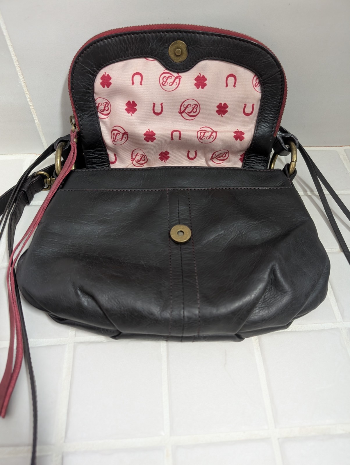 Lucky Brand Black Leather Crossbody Bag with Red Trim and Adjustable Strap