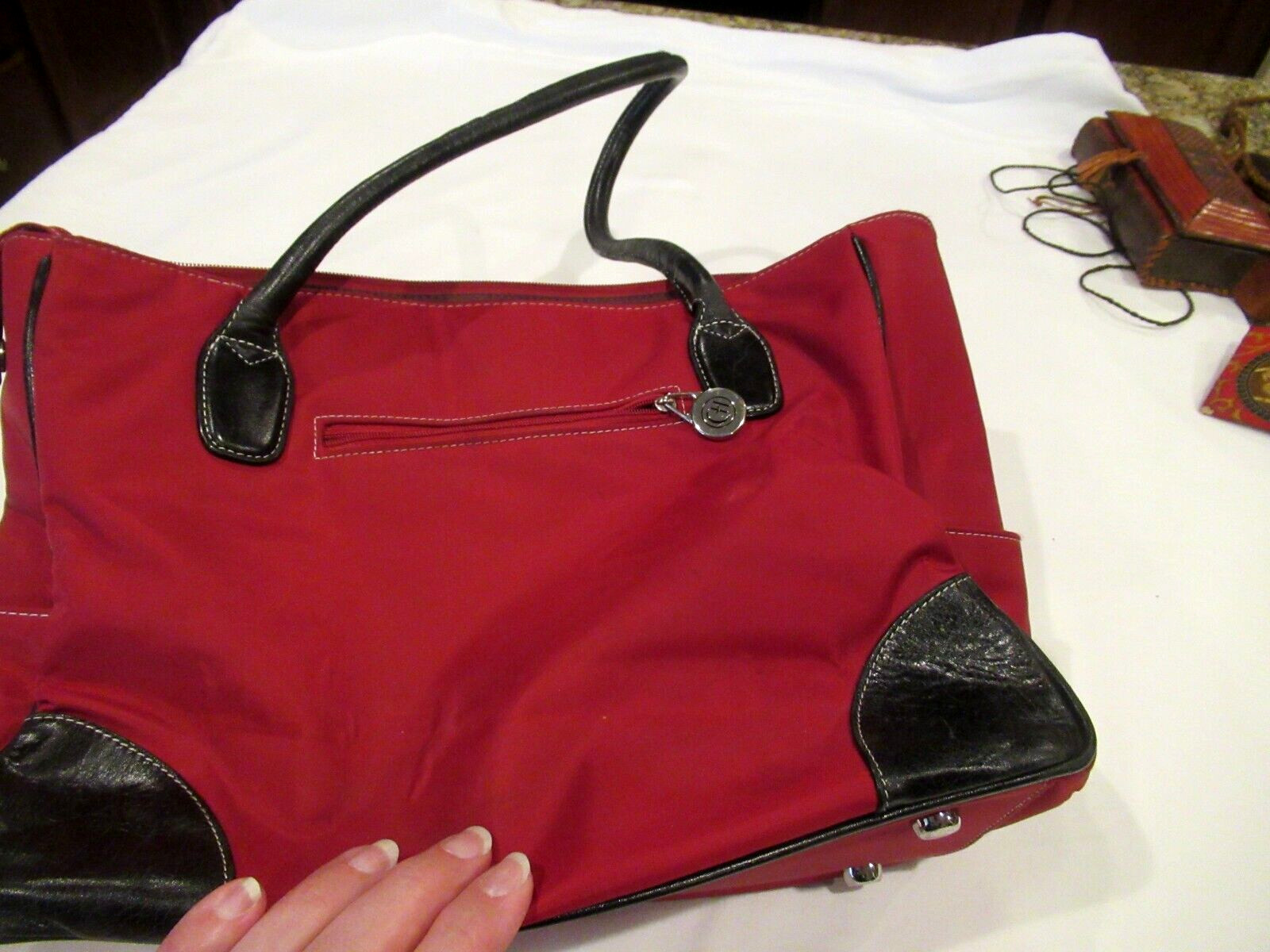 Chelsey Henry red purse with black trim, lots of pockets