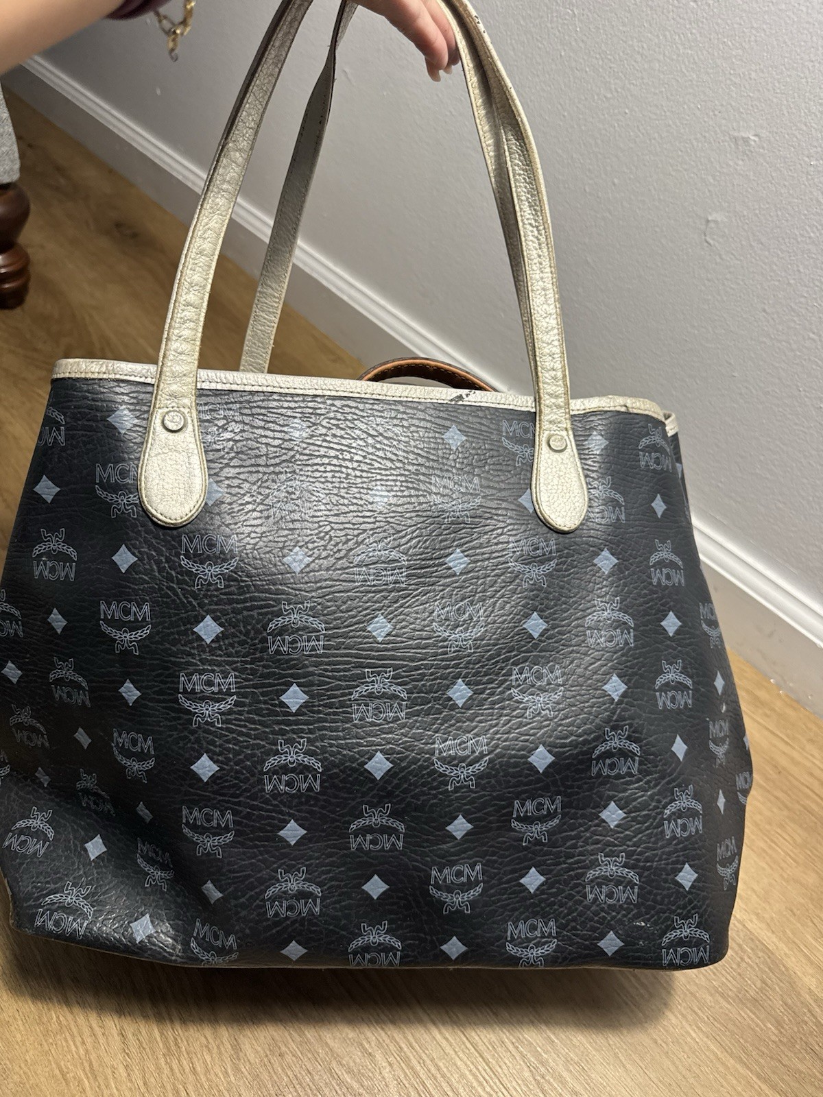 MCM black & gray tote bag with repeating white MCM logo and diamond pattern