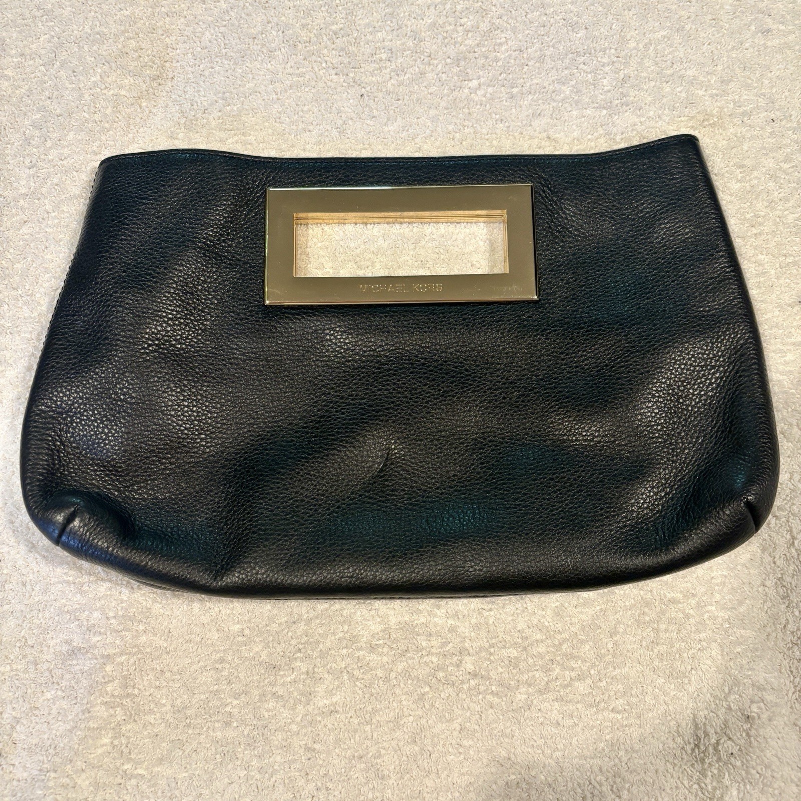 Michael Kors Berkley Black Clutch Features a gold-tone rectangular handle